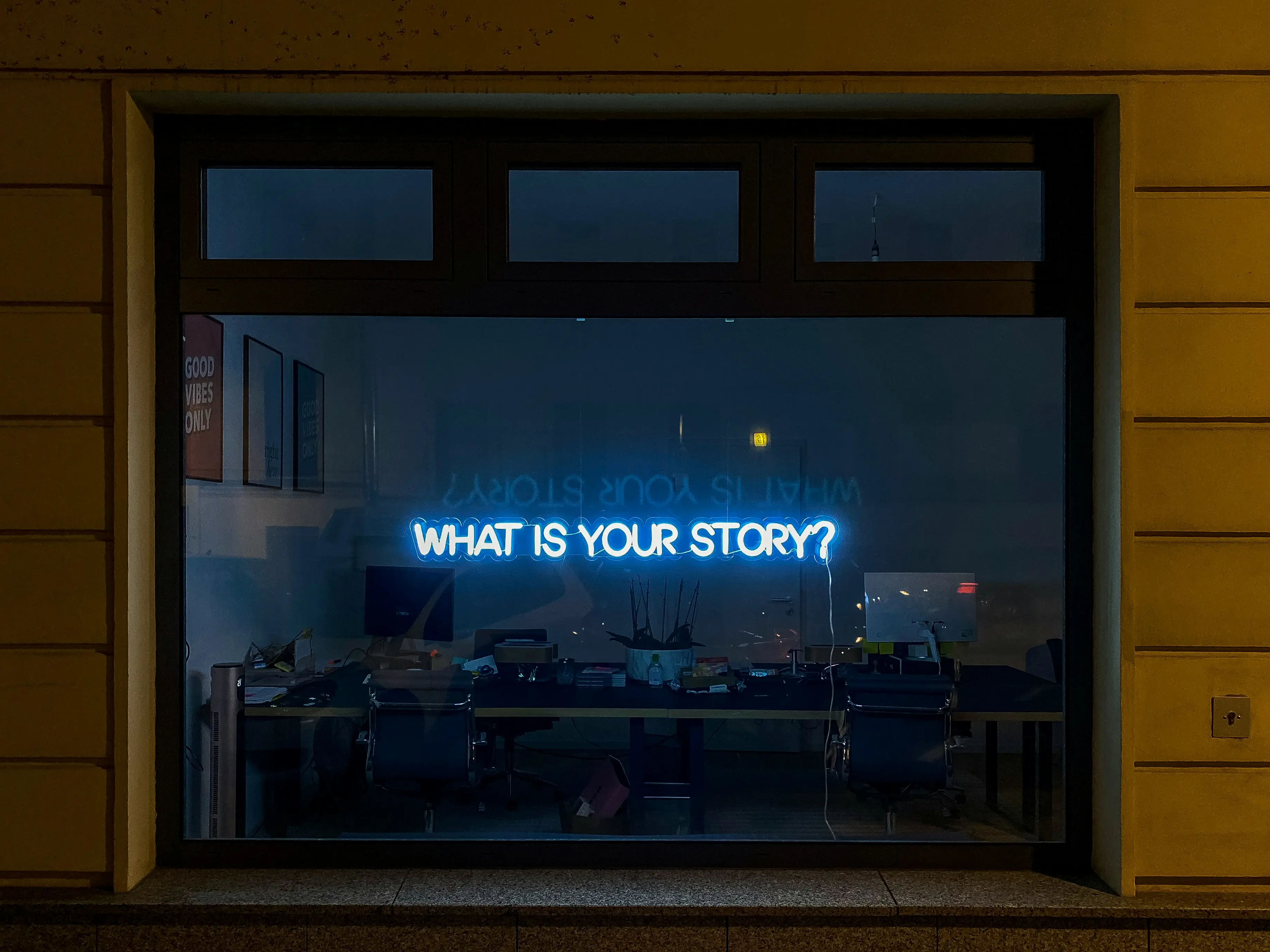 Neon sign saying 'What is your story?'